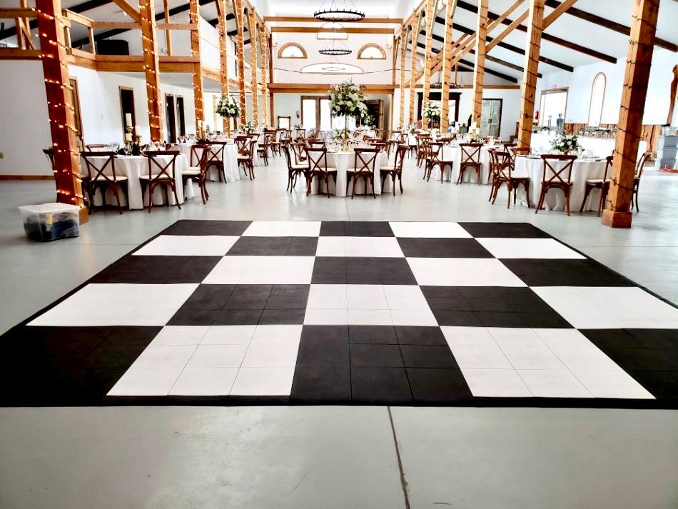 The Black and White Slate style checkered dance floor is a classic touch to this indoor venue.